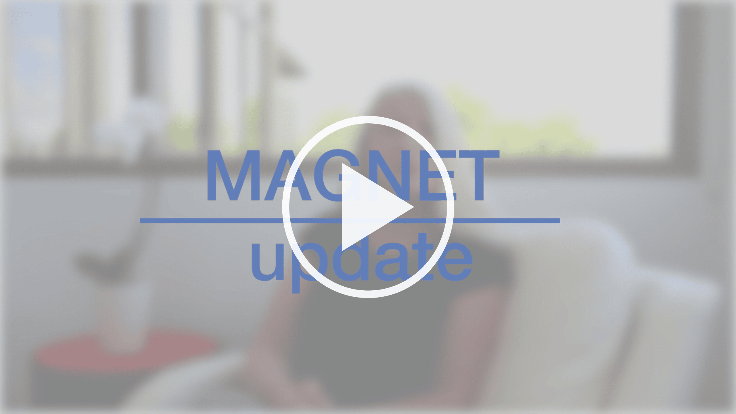 Play button and Magnet update title card in front of blurred image of Magnet selfie video