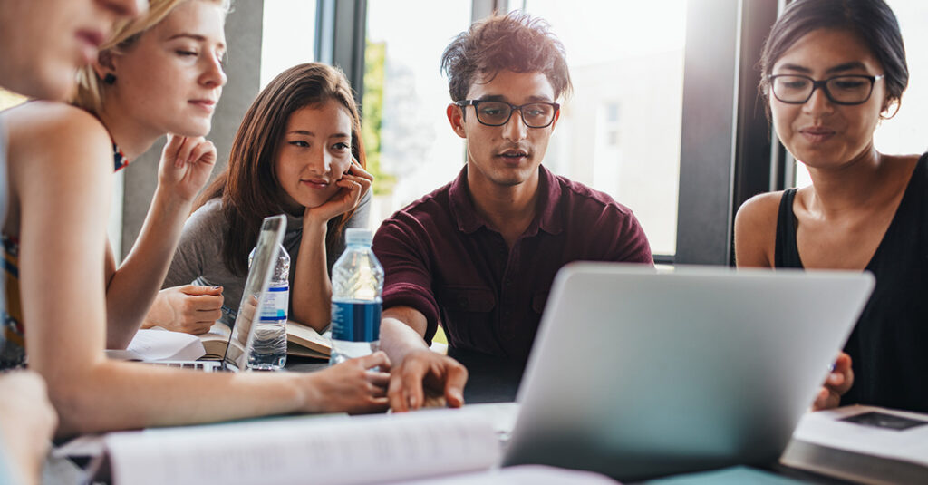 Students gathered around a computer